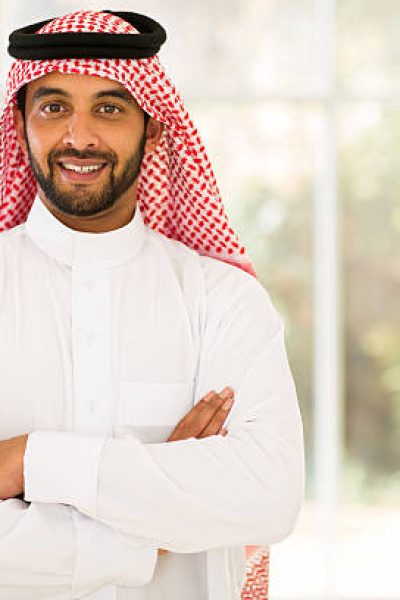 smiling arabian man with arms crossed